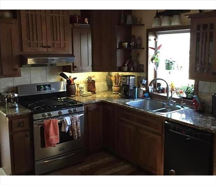 Clean kitchen with stove and sink