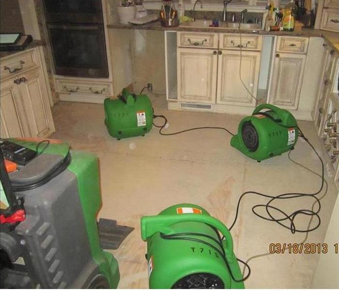 drying equipment in a water damaged kitchen