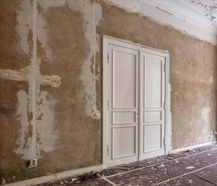 An older home with french doors and crown molding in need of restoration.