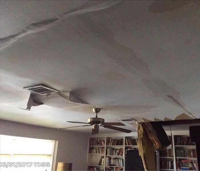 ceiling visibly damaged by water, hanging batten through the ceiling